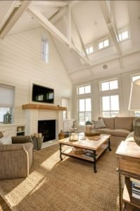 comfortable-casual-neutral-family-room-centers-on-the-seagrass-rug-and-high-vaulted-and-beamed-ceiling