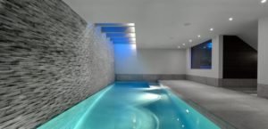 modern-indoor-swimming-pool-design-with-nice-lighting-and-wall-decoration