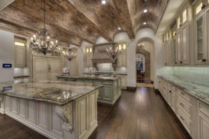 luxury-mediterranean-kitchen-with-arched-brick-ceiling-off-white-cabinetry-and-crystal-chandeliers